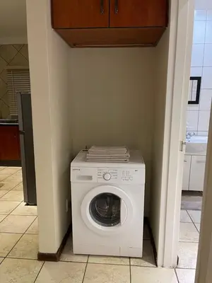 a white washer and dryer in a room at Thorntree Self Catering Apartment, Witbank in Witbank