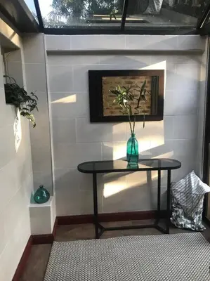 a table with a vase on it in a room at Kyasaja Home away from home in Pretoria
