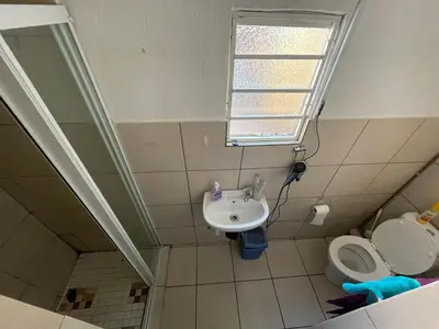 a bathroom with a sink and a toilet at Smartshelter Richard in Pretoria