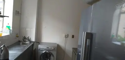 a kitchen with a sink and a washing machine at 4-Bedroom Apartment in Pretoria
