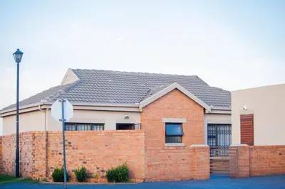 a red brick house with a brick fence at Marelden security estate in Witbank