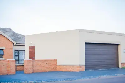 a building with a garage door on the side of it at Marelden security estate in Witbank