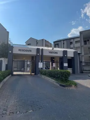 a parking lot in front of a building at Classy 2 bedroom in Halfway Gardens in Midrand