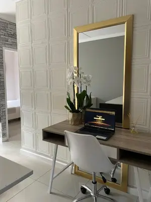 a desk with a laptop and a mirror at Classy 2 bedroom in Halfway Gardens in Midrand