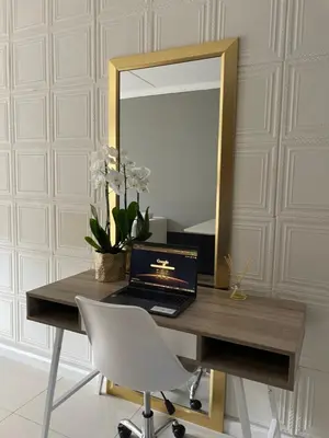 a desk with a laptop and a mirror at Classy 2 bedroom in Halfway Gardens in Midrand