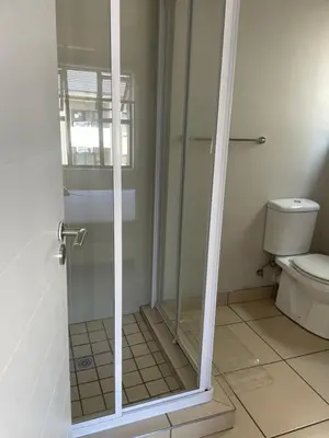 a glass shower in a bathroom with a toilet at Classy 2 bedroom in Halfway Gardens in Midrand