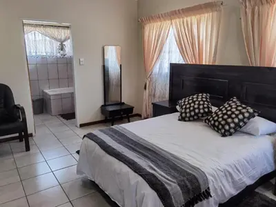 a bedroom with a large bed with pillows on it at Lunford Garden Cottage in Rayton