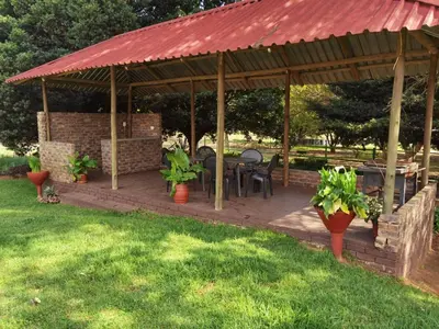 a pavilion with a table and chairs in a yard at Lunford Garden Cottage in Rayton