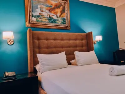 a bedroom with a bed with a blue wall at Red Apple Guest House in Pretoria