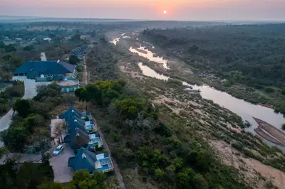 an aerial view of a house next to a river at Leopard Sands Kruger Park in Skukuza