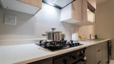 a tea kettle sitting on top of a stove in a kitchen at Modern Midrand Gem in Midrand