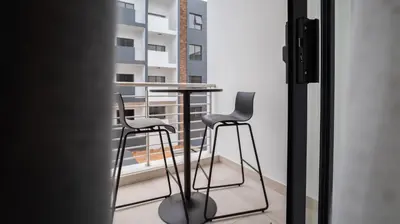 a balcony with a table and two chairs at Modern Midrand Gem in Midrand