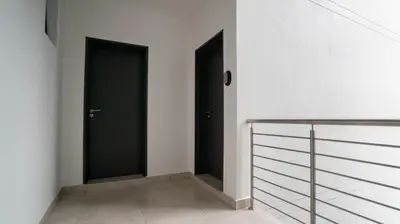 two black doors in a room with white walls at Modern Midrand Gem in Midrand