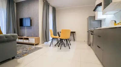 a kitchen with a table and chairs in a room at Modern Midrand Gem in Midrand