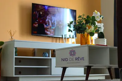 a tv in a living room with a nid de revyne box at Nid de Rêve Accommodation in Midrand