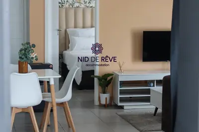 a living room with a bed and a table and chairs at Nid de Rêve Accommodation in Midrand