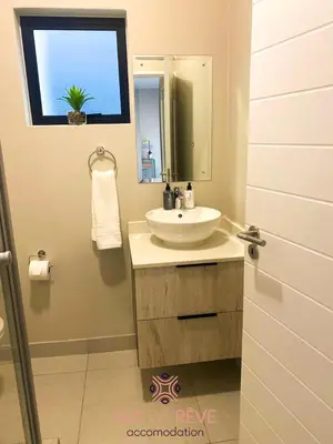 a bathroom with a sink and a mirror and a window at Nid de Rêve Accommodation in Midrand
