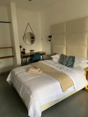 a bedroom with a large bed and a table at TnB Guesthouse in Middelburg
