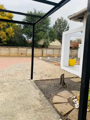 a mirror is sitting on the side of a patio at TnB Guesthouse in Middelburg
