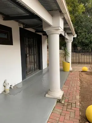 a front porch with columns and a door at TnB Guesthouse in Middelburg