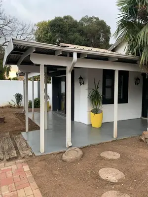 a porch of a white house with a potted plant at TnB Guesthouse in Middelburg