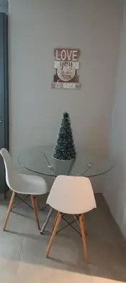 a glass table with a christmas tree and two chairs at Circa unit 91 in Pretoria