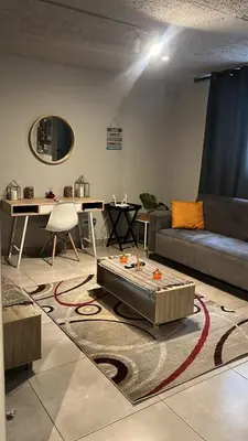 a living room with a couch and a table at Circa unit 91 in Pretoria