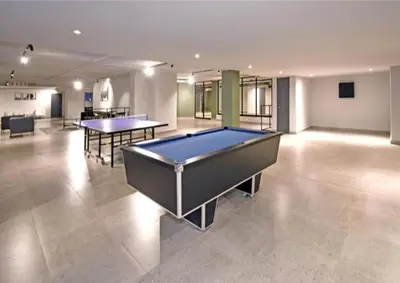 a pool table in a large room with two tables at Circa unit 91 in Pretoria