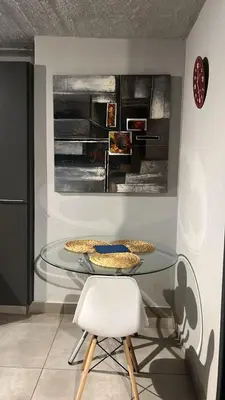 a glass table with two pizzas on it in a room at Circa unit 91 in Pretoria
