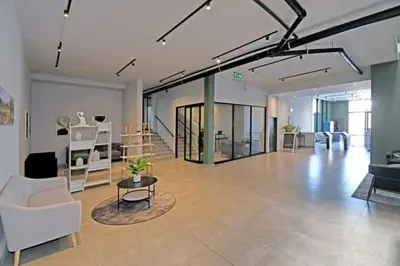 a living room with a white couch and a table at Circa unit 91 in Pretoria