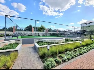 a garden with plants and a tennis court at URlyfstyle Apex Executive 8min to Mall of Africa in Midrand