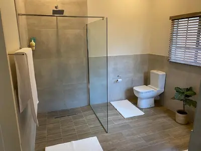 a bathroom with a shower and a toilet at De Vlei - Private Accommodation in Garsfontein in Pretoria