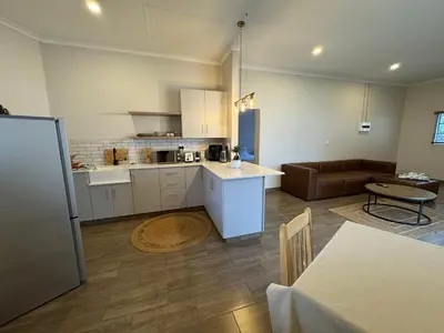a kitchen and a living room with a couch at De Vlei - Private Accommodation in Garsfontein in Pretoria