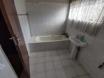 a bathroom with a tub and a toilet and a sink at GLESTER GUEST HOUSE in Pretoria