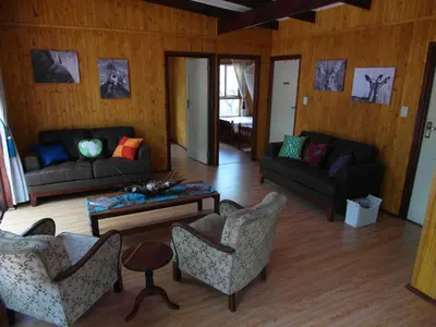 a living room with couches and a table at Blyde River Cabins in Hoedspruit