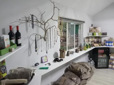 a room with shelves with wine bottles and a window at Blyde River Cabins in Hoedspruit