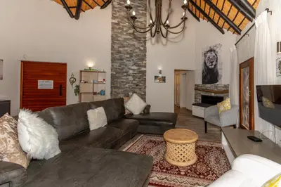 a living room with a couch and a table at Kruger Park Lodge Unit No. 253 in Hazyview