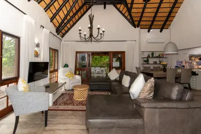 a living room with a couch and a table at Kruger Park Lodge Unit No. 253 in Hazyview
