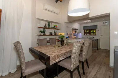 a dining room table with chairs and a kitchen at Kruger Park Lodge Unit No. 253 in Hazyview