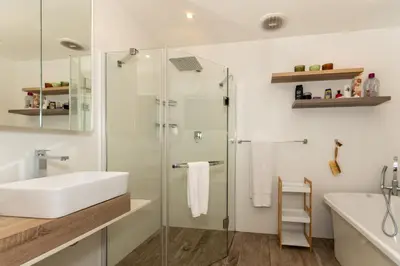 a bathroom with a glass shower and a sink at Kruger Park Lodge Unit No. 253 in Hazyview