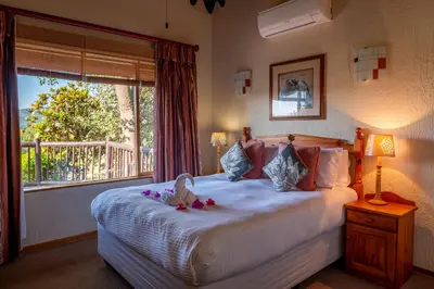 a bedroom with a bed with a stuffed animal on it at Kruger Park Lodge Unit No. 516 in Hazyview