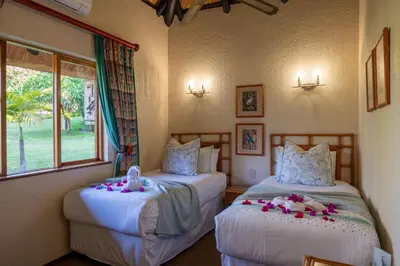 a bedroom with two beds with stuffed animals on them at Kruger Park Lodge Unit No. 516 in Hazyview