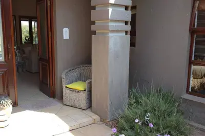 a building with a spiral staircase next to a house at Pecanwood Estate Cosy home 3 bedrooms with pool in Hartbeespoort