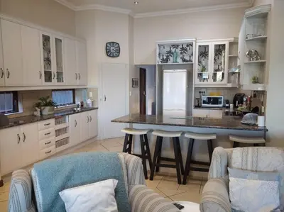 a kitchen with a large island in a room at Pecanwood Estate Cosy home 3 bedrooms with pool in Hartbeespoort