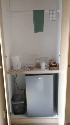 a kitchen with a counter and a small refrigerator at Pecanwood Estate Cosy home 3 bedrooms with pool in Hartbeespoort
