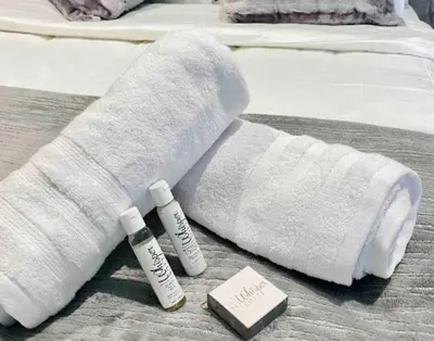 a white sock and two bottles of sunscreen on a bed at Views on the six in Midrand