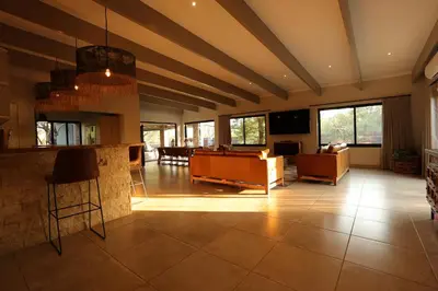 a living room with a couch and a table at Shiandi Villa in Hoedspruit