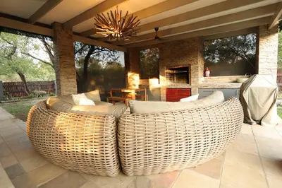 a large wicker couch sitting on a patio at Shiandi Villa in Hoedspruit
