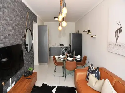 a living room with a couch and a table at ELcaro Luxury Villas-The Cave in Midrand