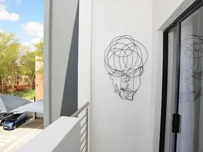 a wrought iron sphere on the side of a building at ELcaro Luxury Villas-The Cave in Midrand